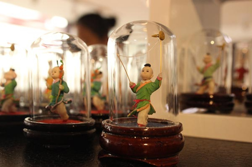The Nanluoguxiang area in Beijing is a new center for craftsmen to revive cultural heritage such as snuffbox miniature paintings and figurines (above). (Wang Kaihao/China Daily) The Nanluoguxiang area in Beijing is a new center for craftsmen to revive cultural heritage such as snuffbox miniature paintings and figurines (above). (Wang Kaihao/China Daily)