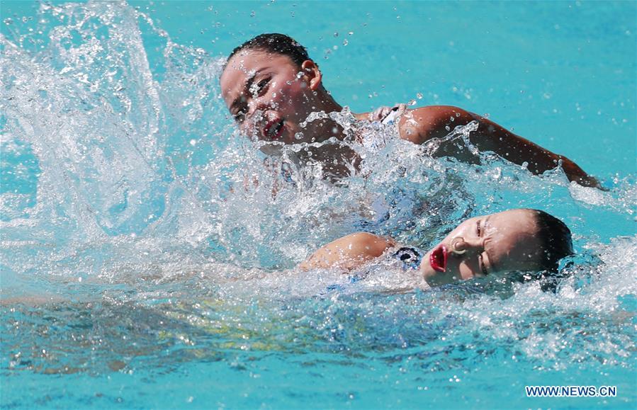 Swimmers compete during duets free routine preliminaries of Synchronised Swimming (1/10)