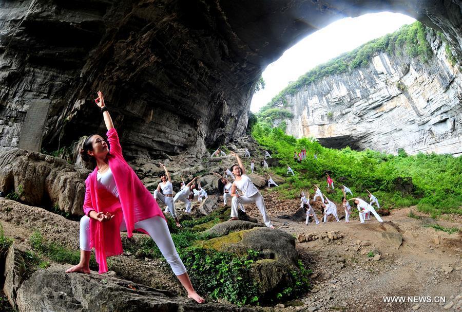 Yoga fans practice at central China's Moon Rock sinkhole (1/5)