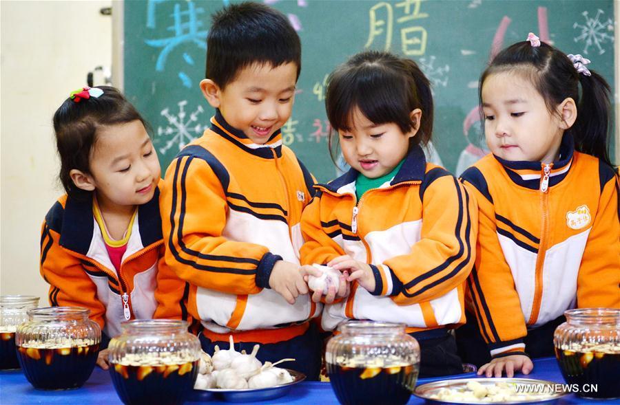 Children eat Laba congee in north China's Hebei (1/4)