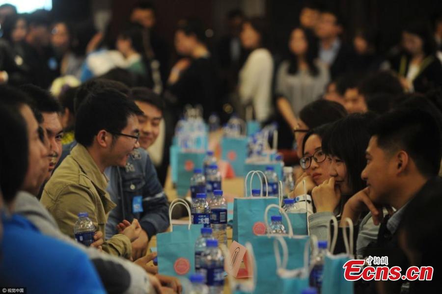 Singles attend a blind date at a hotel in Haidian District, Beijing, April 9, 2017. More than 1,000 single men and women who are studying at top schools such as Peking, Tsinghua and Renmin universities participated the event that lasted for four hours and included five-minute speed dates and games. Some students said they joined the activity because they feel bored alone and regard being in a relationship as a kind of skill. Some participants met about 500 people through the event. The organizer said participants were born in 1999 or earlier. (Photo/CFP)