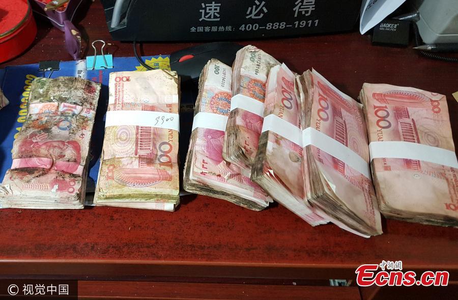 Veteran bank staff uses hot water to clean damaged money(1/3)