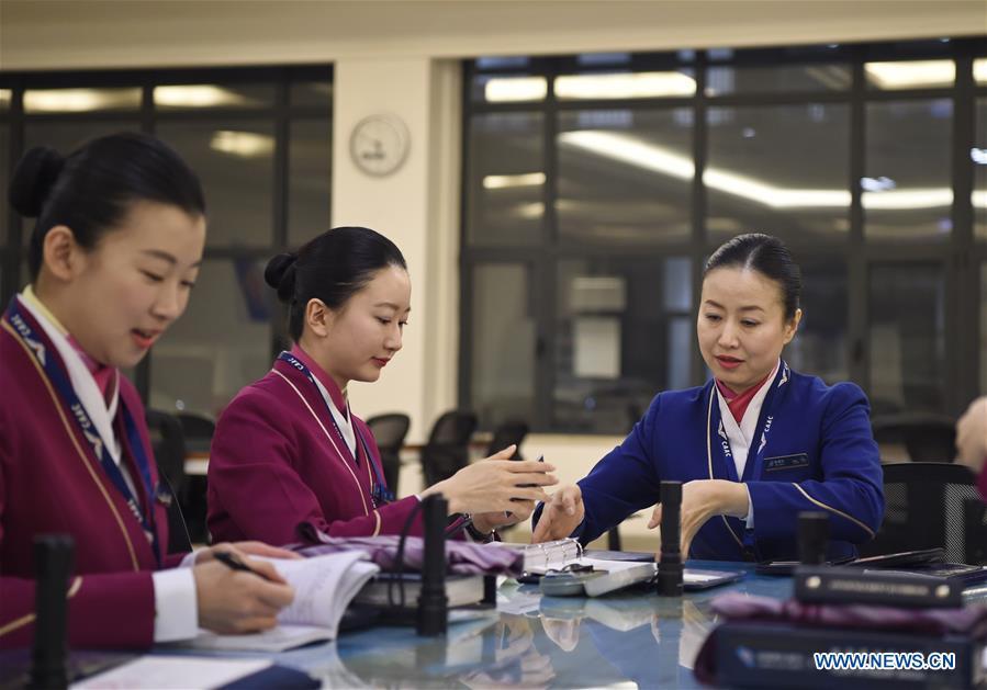 Zhu Aijun (R) and her daughter Li Xinyun (C) attends the preparatory meeting before flight in Shenyang, capital of northeast China's Liaoning Province, Nov. 17, 2017. Zhu Aijun has been a flight attendant in China Southern Airlines since 1987, and Friday is her last flight before retirement. Her daughter Li Xinyun, who became a flight attendant in 2016, has been permitted to fly with her mother. (Xinhua/Long Lei)
