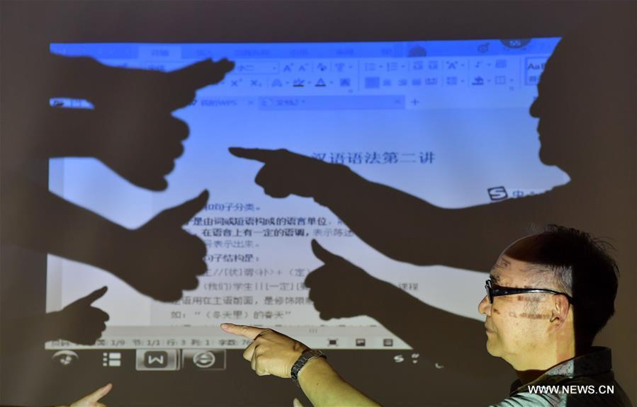 He Xingwu tells stories with sign language at a special school in Nanchang, east China's Jiangxi Province, Sept. 13, 2017. The 74-year-old teacher He Xingwu has worked in the speical school for 23 years. (Xinhua/Peng Zhaozhi)