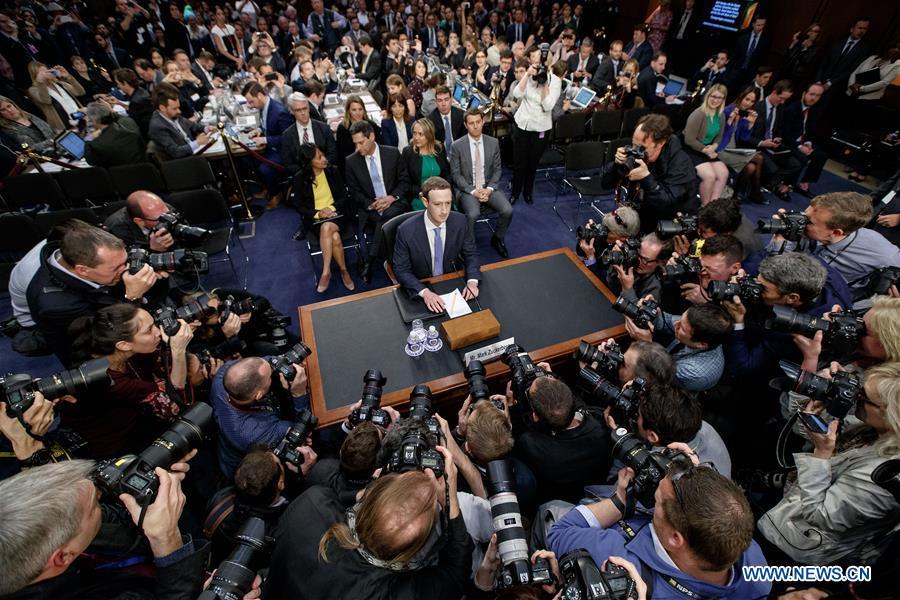 Facebook CEO Mark Zuckerberg (C) arrives to testify at a joint hearing of the Senate Judiciary and Commerce committees on Capitol Hill in Washington D.C., United States, on April 10, 2018. Facebook CEO Mark Zuckerberg told Congress in written testimony on Monday that he is \