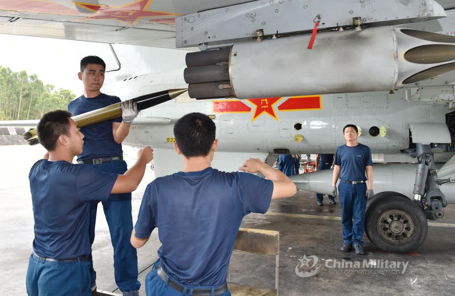 Ordnancemen assigned to an aviation brigade of the South China Sea Fleet under the PLA Navy load ammunition onto a fighter jet prior to a live-fire training exercise at a shooting range in the South China Sea from May 17 to 18, 2018. (Photo/eng.chinamil.com.cn)