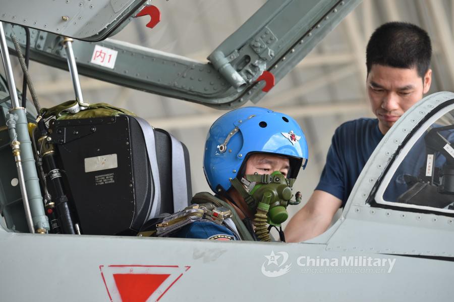 A pilot assigned to an aviation brigade of the South China Sea Fleet under the PLA Navy goes through pre-flight procedures prior to a live-fire training exercise at a shooting range in the South China Sea from May 17 to 18, 2018. (Photo/eng.chinamil.com.cn)