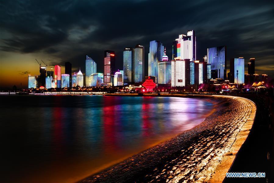 Photo taken on April 14, 2018 shows the night view of Fushan Bay in Qingdao, a coastal city in east China\'s Shandong Province. Home to Tsingtao Beer and home appliance giant Haier, Qingdao is becoming a more attractive place to run important multilateral events. In June, the coastal city will host the 18th summit of the Shanghai Cooperation Organization (SCO). (Xinhua/Guo Xulei)