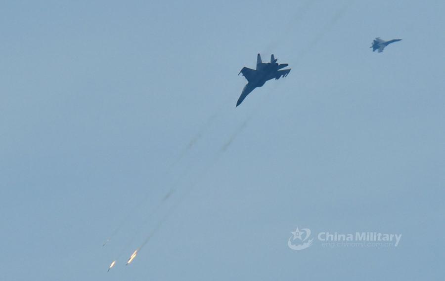A fighter jet attached to an aviation brigade of the South China Sea Fleet under the PLA Navy fires at mock sea targets during a live-fire training exercise at a shooting range in the South China Sea from May 17 to 18, 2018. (Photo/eng.chinamil.com.cn)