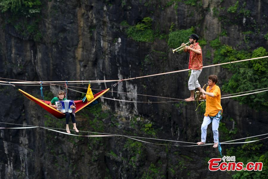 Members of the band HouleDouse perform on slacklines across the 1,400-meter-high cliffs of Tianmen Mountain in Zhangjiajie National Forest Park in central China\'s Hunan province, on Wednesday, May 23, 2018. HouleDouse have made their Asian debut in China, in a show that combines extreme sports with music. (Photo: China News Service/ Yang Huafeng)