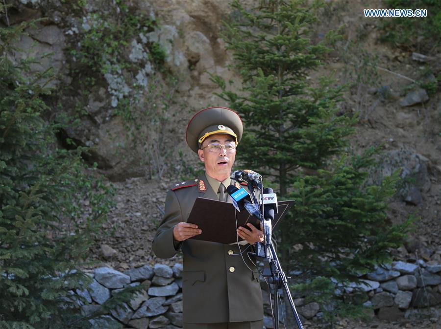 An official of the Nuclear Weapons Institute of the Democratic People\'s Republic of Korea (DPRK) announces a statement at the nuclear test site of Punggye-ri, the Democratic People\'s Republic of Korea, on May 24, 2018. The Democratic People\'s Republic of Korea has confirmed the demolition of its nuclear test site at Punggye-ri on Thursday, saying that all the tunnels have been collapsed by explosions and their entrances completely closed, according to the Korean Central News Agency (KCNA). (Xinhua/Cheng Dayu)