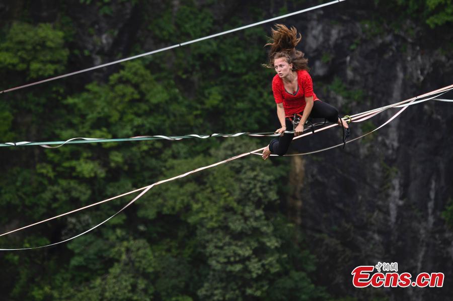 Members of the band HouleDouse perform on slacklines across the 1,400-meter-high cliffs of Tianmen Mountain in Zhangjiajie National Forest Park in central China\'s Hunan province, on Wednesday, May 23, 2018. HouleDouse have made their Asian debut in China, in a show that combines extreme sports with music. (Photo: China News Service/ Yang Huafeng)