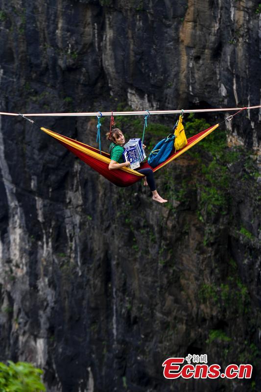 Members of the band HouleDouse perform on slacklines across the 1,400-meter-high cliffs of Tianmen Mountain in Zhangjiajie National Forest Park in central China\'s Hunan province, on Wednesday, May 23, 2018. HouleDouse have made their Asian debut in China, in a show that combines extreme sports with music. (Photo: China News Service/ Yang Huafeng)