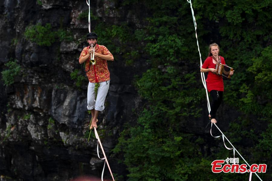 Members of the band HouleDouse perform on slacklines across the 1,400-meter-high cliffs of Tianmen Mountain in Zhangjiajie National Forest Park in central China\'s Hunan province, on Wednesday, May 23, 2018. HouleDouse have made their Asian debut in China, in a show that combines extreme sports with music. (Photo: China News Service/ Yang Huafeng)