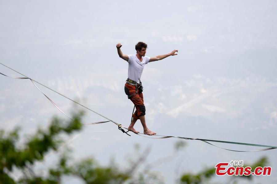 Members of the band HouleDouse perform on slacklines across the 1,400-meter-high cliffs of Tianmen Mountain in Zhangjiajie National Forest Park in central China\'s Hunan province, on Wednesday, May 23, 2018. HouleDouse have made their Asian debut in China, in a show that combines extreme sports with music. (Photo: China News Service/ Yang Huafeng)