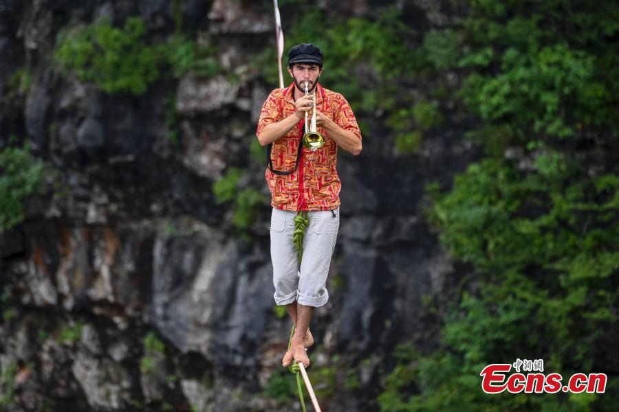 Members of the band HouleDouse perform on slacklines across the 1,400-meter-high cliffs of Tianmen Mountain in Zhangjiajie National Forest Park in central China\'s Hunan province, on Wednesday, May 23, 2018. HouleDouse have made their Asian debut in China, in a show that combines extreme sports with music. (Photo: China News Service/ Yang Huafeng)