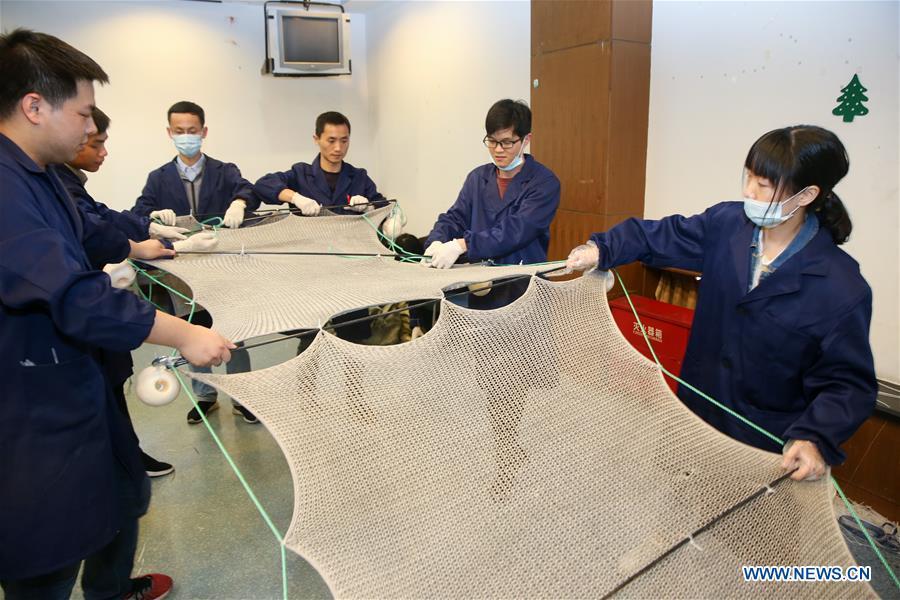 Team captained by Huang Fuqiang, chief researcher at the Shanghai Institute of Ceramics of Chinese Academy of Sciences, assembles the composite material at the Shanghai Institute of Ceramics of Chinese Academy of Sciences in east China\'s Shanghai, April 24, 2018. A new composite material developed by a group of Chinese researchers has proved highly effective in cleaning water contaminated by organics. (Xinhua/Ding Ting)