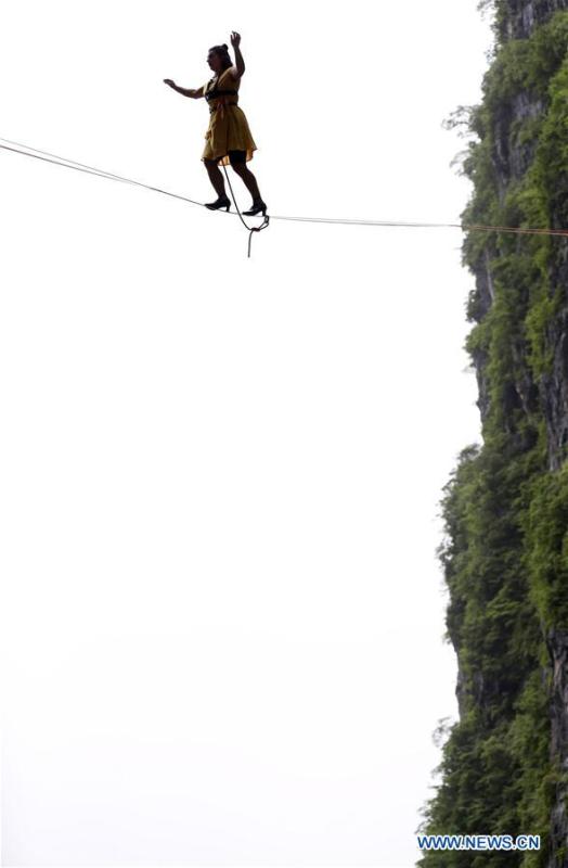 Mia Noblet of Canada participates in a slackline contest in high heels in Zhangjiajie, central China\'s Hunan Province, May 27, 2018. (Xinhua/Zhou Guoqiang)