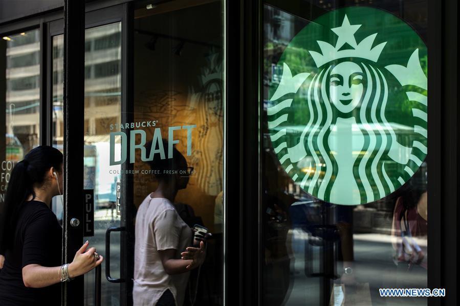 People walk into a Starbucks store in Manhattan, New York, the United States, May 29, 2018. Starbucks closed about 8,000 company-owned stores in the United States on Tuesday afternoon to offer nearly 175,000 employees a mandatory anti-bias training. (Xinhua/Li Muzi)
