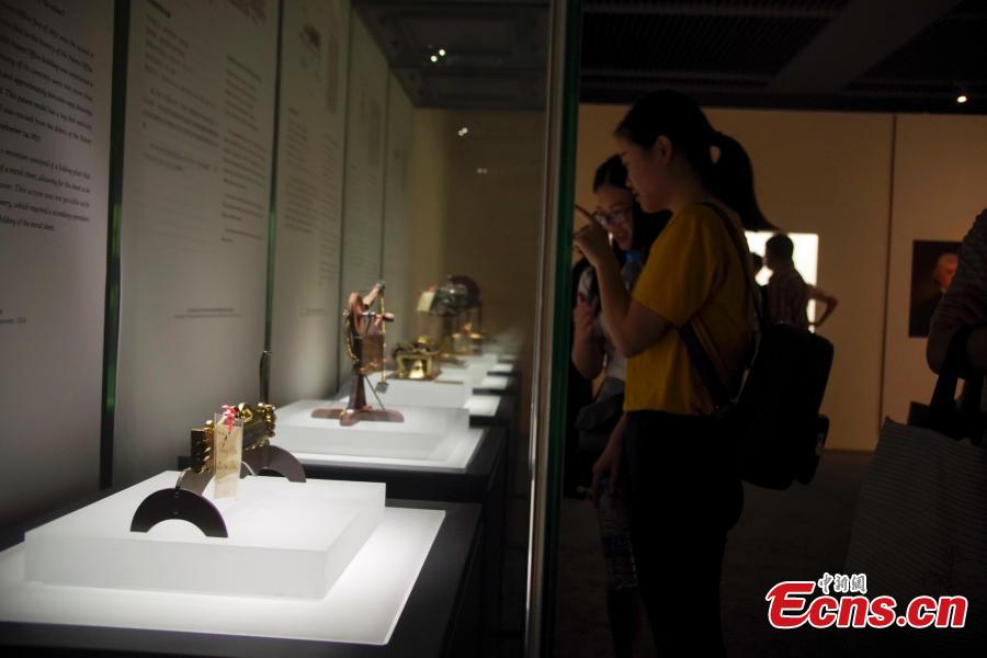 Visitors view items in the Spirit of Invention: Nineteenth-Century U.S. Patent Models from the Hagley Museum and Library exhibition at the National Museum of China in Beijing, June 3, 2018. The exhibition presented 60 of Hagley’s 19th-century patent models. (Photo: China News Service/Jia Tianyong)