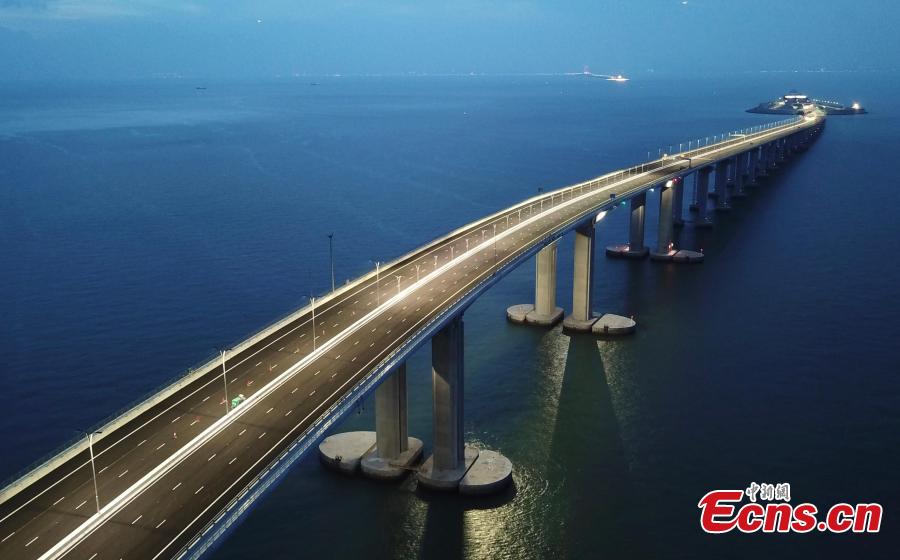 A view of part of the Hong Kong-Zhuhai-Macao Bridge, illuminated at night. The 55-kilometer Hong Kong-Zhuhai-Macao Bridge, the world\'s longest sea bridge, will slash the travel time between Hong Kong and Zhuhai from three hours to just 30 minutes, further integrating cities in the Pearl River Delta. (Photo: China News Service/Sheung Man Mak)