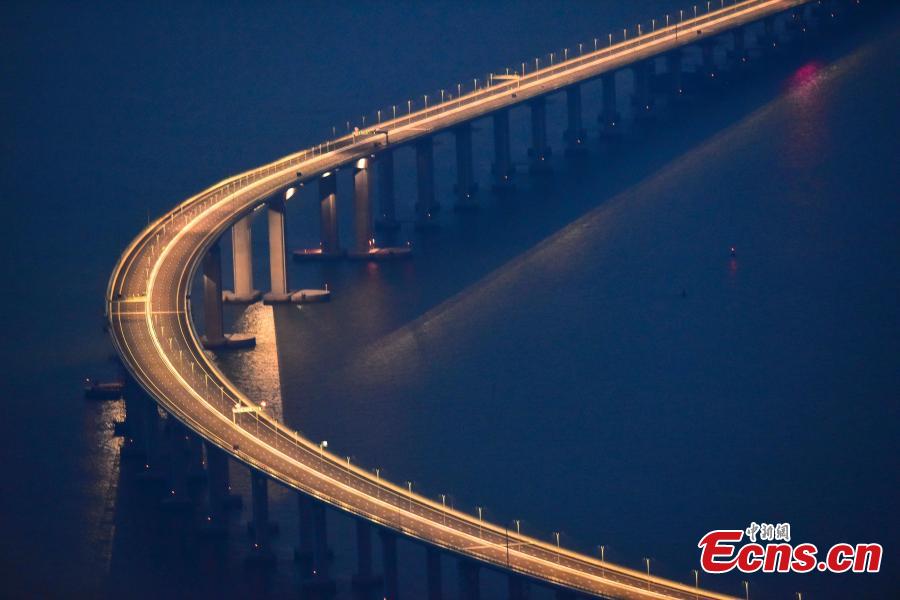 A view of part of the Hong Kong-Zhuhai-Macao Bridge, illuminated at night. The 55-kilometer Hong Kong-Zhuhai-Macao Bridge, the world\'s longest sea bridge, will slash the travel time between Hong Kong and Zhuhai from three hours to just 30 minutes, further integrating cities in the Pearl River Delta. (Photo: China News Service/Sheung Man Mak)