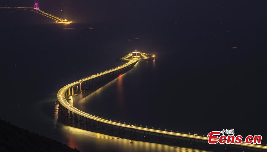 A view of part of the Hong Kong-Zhuhai-Macao Bridge, illuminated at night. The 55-kilometer Hong Kong-Zhuhai-Macao Bridge, the world\'s longest sea bridge, will slash the travel time between Hong Kong and Zhuhai from three hours to just 30 minutes, further integrating cities in the Pearl River Delta. (Photo: China News Service/Sheung Man Mak)