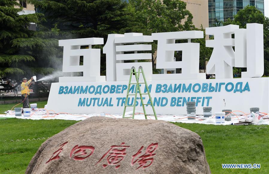 A staff member decorates a sign of Shanghai Cooperation Organization (SCO) Summit in Qingdao, east China\'s Shandong Province, June 2, 2018. The 18th SCO Summit is scheduled for June 9 to 10 in Qingdao. (Xinhua/Ma Ning)