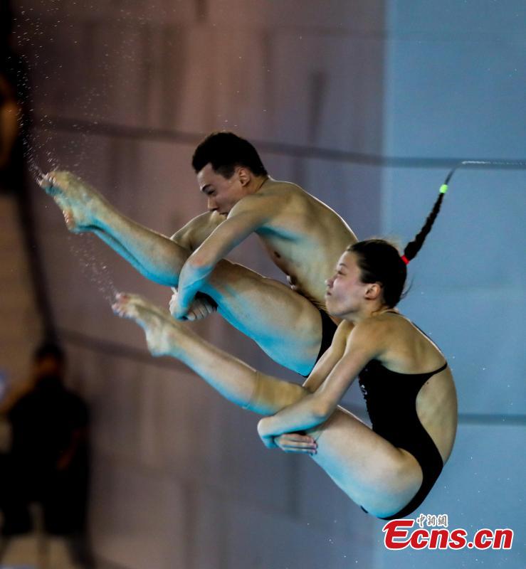 Canadian divers compete in the mixed 10-meter synchronized platform at the FINA Diving World Cup in Wuhan City, Central China’s Hubei Province, June 4, 2018. (Photo: China News Service/Zhang Chang)