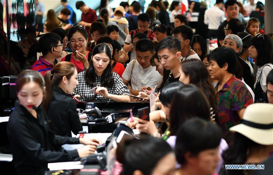 Tourists visit a duty free shop in Sanya, south China\'s Hainan Province, Feb. 18, 2018. Hainan aims to be an international tourism consumption center. (Xinhua/Guo Cheng)