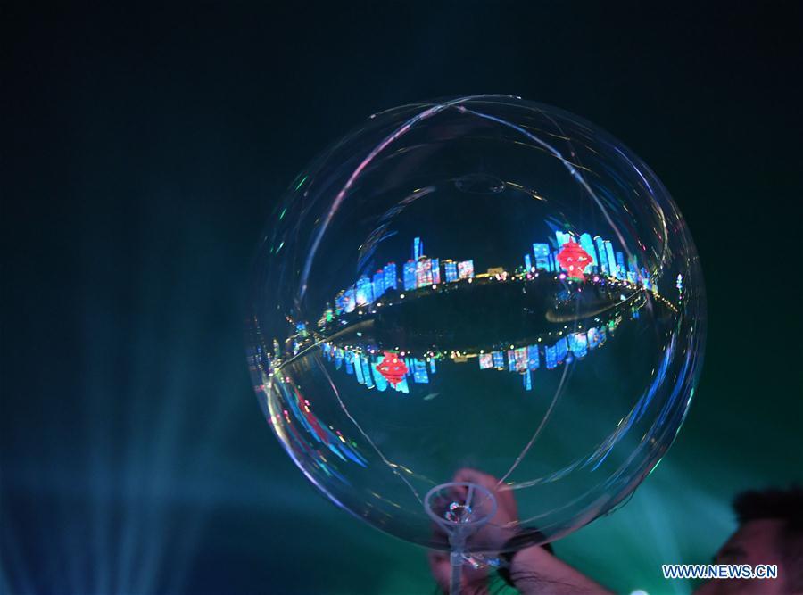 Photo taken on June 1, 2018 shows the reflection of Wusi Square on a balloon in Qingdao, east China\'s Shandong Province. The 18th Shanghai Cooperation Organization (SCO) Summit is scheduled for June 9 to 10 in Qingdao. (Xinhua/Jin Liangkuai)