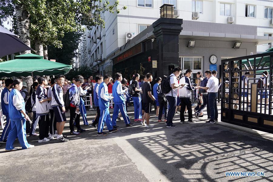 Examinees enter the exam venue at Beijing No. 4 High School in Beijing, capital of China, June 7, 2018. About 9.75 million students have registered for the national college entrance examination, which takes place from June 7 to 8. (Xinhua/Shen Bohan)