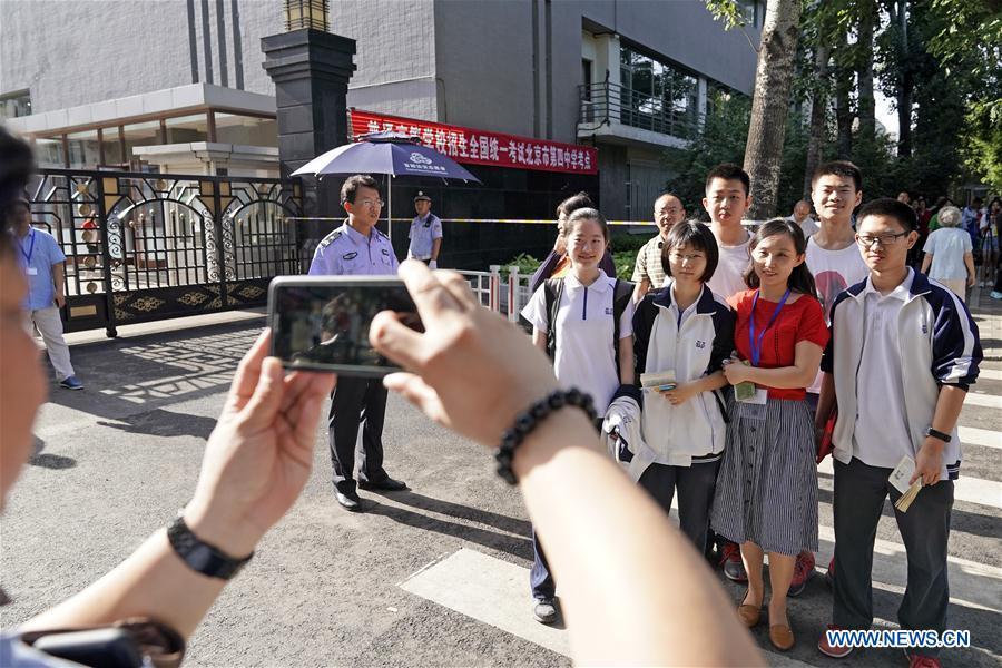 Examinees pose for a group photo outside the exam venue at Beijing No. 4 High School in Beijing, capital of China, June 7, 2018. About 9.75 million students have registered for the national college entrance examination, which takes place from June 7 to 8. (Xinhua/Shen Bohan)