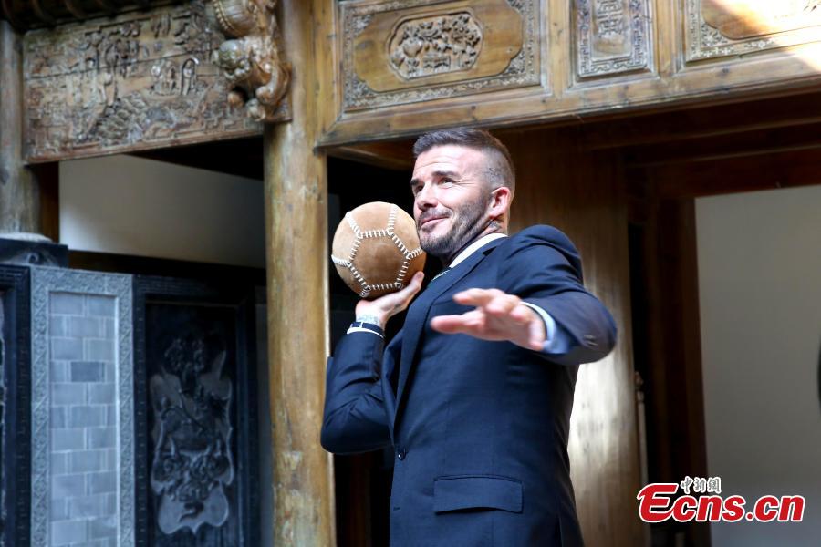 Former professional football star David Beckham plays cuju, known as the origin of modern football, at the Bengbu Ancient Buildings Expo Park ahead of the 2018 G-EXPO Global Top Summit in Bengbu City, East China’s Anhui Province, June 6, 2018. (Photo: China News Service/Zhong Xin)