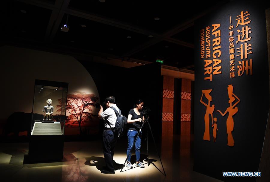 Journalists take photos at the African Art Exhibition in southwest China\'s Chongqing, June 7, 2018. The exhibition will open to the public from June 8 to Sept. 9. (Xinhua/Wang Quanchao)