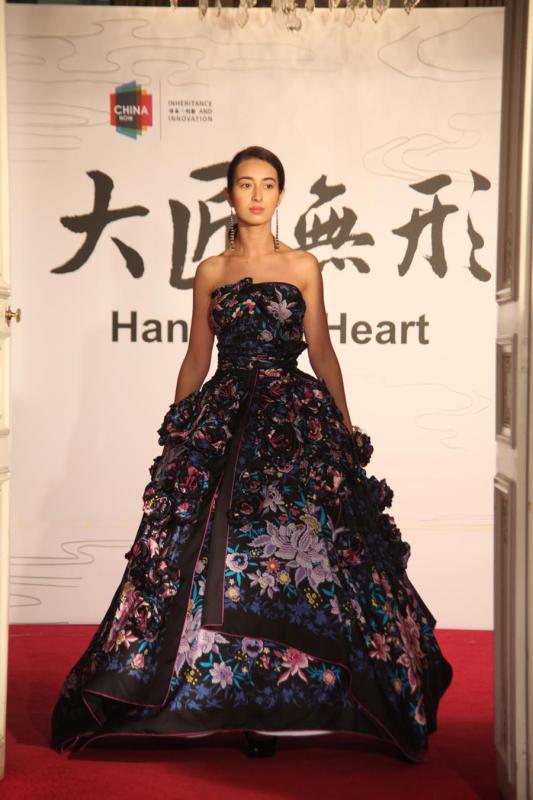 A model shows a silk flower dress at the Paris China Cultural Center on June 5, 2018. (Photo provided to Chinaculture.org)