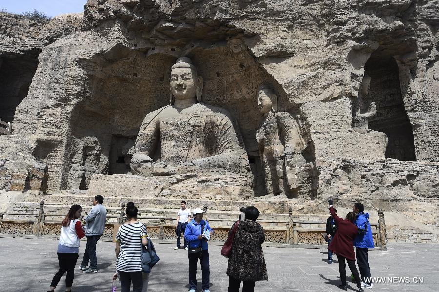 Tourists visit the Yungang Grottoes in Datong, north China\'s Shanxi Province, April 22, 2015. The Yungang Grottoes, listed as a UNESCO World Cultural Heritage site in 2001, will witness a tourism peak as the May Day holiday is coming. (Photo: Xinhua/Yan Yan)

12. Yungang Grottoes

Located at the southern foot of the Wuzhou Mountain, some 16 km west of Datong city, Shanxi province, the Yungang Grottoes were built against the mountain and extend about one km (0.62 miles) from east to west.

Comprising 252 caves and 51,000 statues within a carved area of 18,000 square meters, Yungang Grottoes represent the outstanding achievement of Buddhist cave art in China during the 5th and 6th centuries.

The Five Caves created by Tan Yao, with their strict unity of layout and design, constitute a classical masterpiece of the first peak of Chinese Buddhist art.

Yungang Grottoes were added to the World Cultural Heritage List in December 2001.