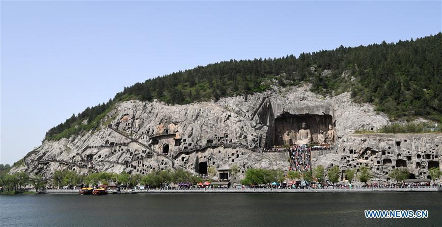 Tourists visit the Longmen Grottoes in Luoyang, central China\'s Henan Province, April 17, 2017. The Longmen Grottoes has entered into tourist rush season. (Xinhua/Zhu Xiang)

15. Longmen Grottoes

These grottoes reflect the heyday of Tang Dynasty culture (618-907).

Located 13 km south of Luoyang, Henan province, the Longmen Grottoes are concentrated on the east and west cliffs of the Yishui River, and stretch for one km. Work started on the grottoes around the year 493, during the Northern Wei Dynasty, and continued for the next 400 years. 

Large numbers of memorial texts and inscribed stone tablets at the Longmen Grottoes, like the Twenty Gems of Longmen Calligraphy and Zhu Suiliang’s stone tablets, are considered rare treasures of Chinese calligraphy.

The Zhu Suiliang Inscription, made in 641 in honor of the mother of the fourth son of Emperor Taizong, is one of them.

The Longmen Grottoes was added to the list on November 30, 2000.