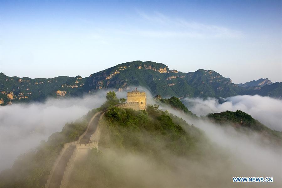 Photo taken on May 13, 2018 shows sea of clouds after rainfall at Huangyaguan section of the Great Wall in Tianjin, north China.(Xinhua/Yang Yushan)
4. The Great Wall

Just like a gigantic dragon, the Great Wall winds up and down across deserts, grasslands, mountains and plateaus, stretching from east to west of China. 

It begins in the east at Shanhaiguan in Hebei province and ends at Jiayuguan in Gansu province to the west. Its main body consists of walls, horse tracks, watch towers, and shelters on the wall, and includes fortresses and passes along the Wall.

With a history of more than 2,000 years, some of the sections are now in ruins or have disappeared. However, it is still one of the most appealing attractions all around the world owing to its architectural grandeur and historical significance.

The Great Wall, one of the greatest wonders of the world, was listed as a World Heritage by UNESCO in 1987.