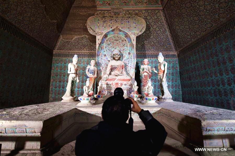 A photographer works in a cave in the Mogao Grottoes in Dunhuang, northwest China\'s Gansu Province, Oct. 10, 2016.(Photo/Xinhua)

5. Mogao caves

Located on south-east of the Dunhuang oasis, Gansu province, the Mogao caves, also known as the Thousand-Buddha Caves, are the world\'s largest, most richly endowed, and longest used treasure house of Buddhist art. They are located at a strategic point along the Silk Road, at the crossroads of trade as well as religious, cultural and intellectual influences.

According to historical records, the carving of the caves started in 366 AD and continued for about 1,000 years. The 492 well-preserved cells and cave sanctuaries in Mogao, housing about 45,000 square meters of murals and more than 2,000 painted sculptures, are well-known for their statues and wall paintings. The painted clay figures vary greatly in size, with the largest one being 33 meters high and the smallest only 10 centimeters.

The Mogao Caves were added to the list in December 1987.