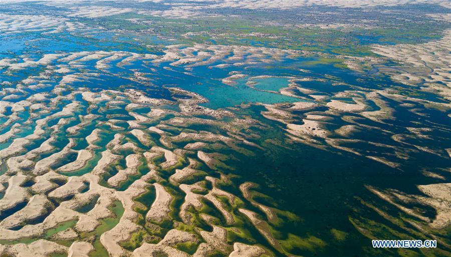 Aerial photo taken on June 9, 2018 shows a wetland in the Kubuqi Desert of Ordos City, north China\'s Inner Mongolia Autonomous Region. The wetland is formed by water of the Yellow River in flood period. (Xinhua/Peng Yuan)