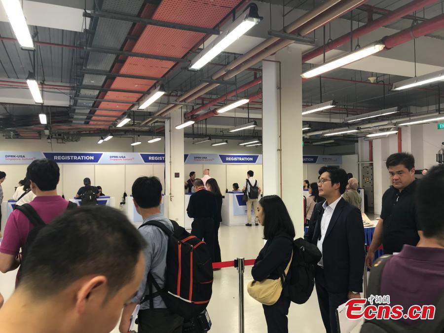 Reporters gather at the International Media Center for the DPRK-USA summit at F1 Pit Building in Singapore, June 10, 2018. (Photo: China News Service/Meng Xiangjun)