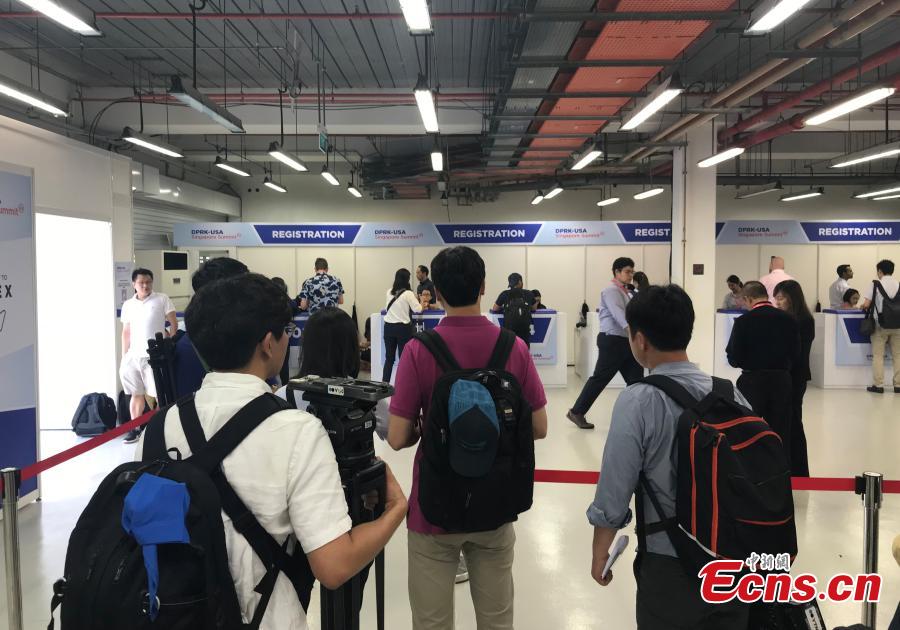 Reporters gather at the International Media Center for the DPRK-USA summit at F1 Pit Building in Singapore, June 10, 2018. (Photo: China News Service/Meng Xiangjun)