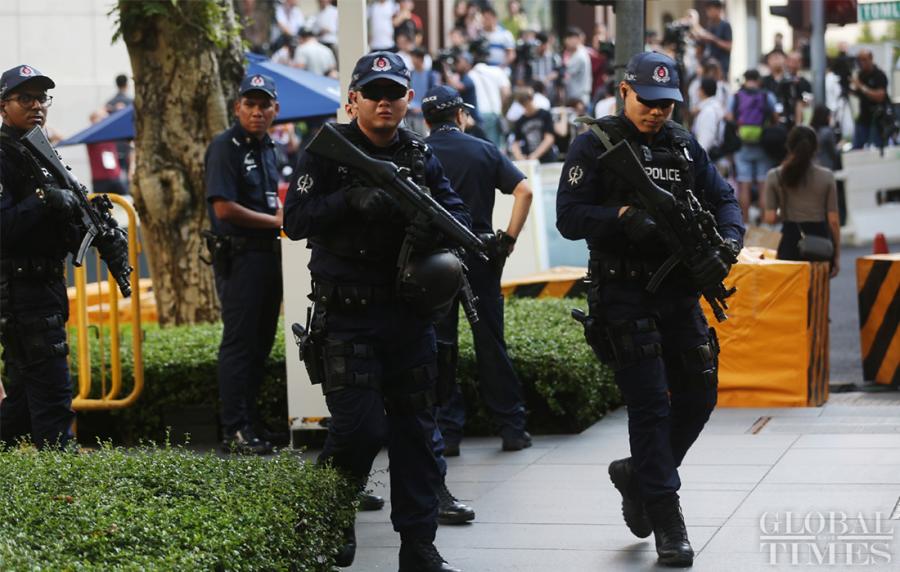Singaporean police on patrol to ensure the security outside the St. Regis hotel where DPRK leader Kim Jong-un has stayed on Sunday.  (Photo: Yang Sheng/GT)