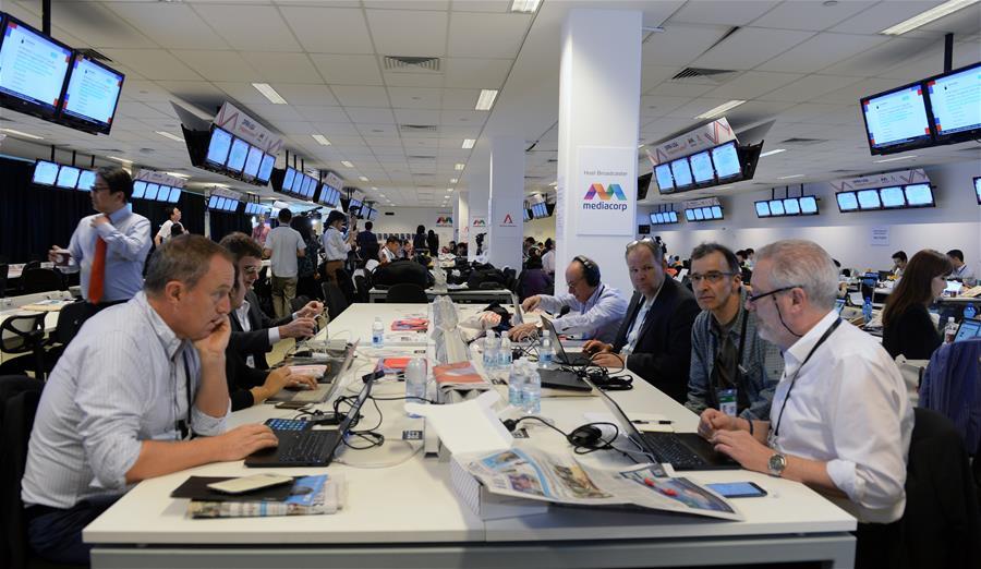 Reporters work at the international media center in Singapore, ahead of the historic summit between top leader of the Democratic People\'s Republic of Korea (DPRK) Kim Jong Un and U.S. President Donald Trump, on June 12, 2018. (Xinhua/Li Peng)