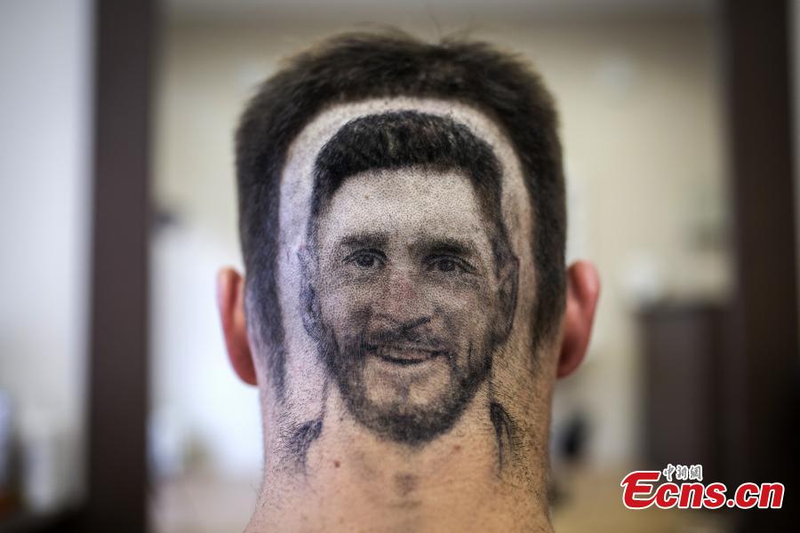 A fan of Lionel Messi shows his new haircut that features the face of the football star in Novi Sad, Serbia ahead of the World Cup. Barber Mario Hvala is famed for his salon in Novi Sad, where he shaves all manner of shapes and faces into customers\' hair. (Photo/Agencies)