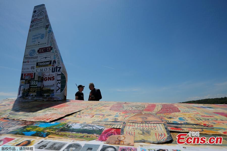 Photo taken on June 12, 2018 shows a massive paper airplane in Fitchburg, U.S. The 64-foot-long plane weighing in at over 1,500 pounds was put together by Project Soar at the Revolving Museum of Fitchburg. Creators of the paper airplane hope it will become a new Guinness World Record. (Photo/Agencies)