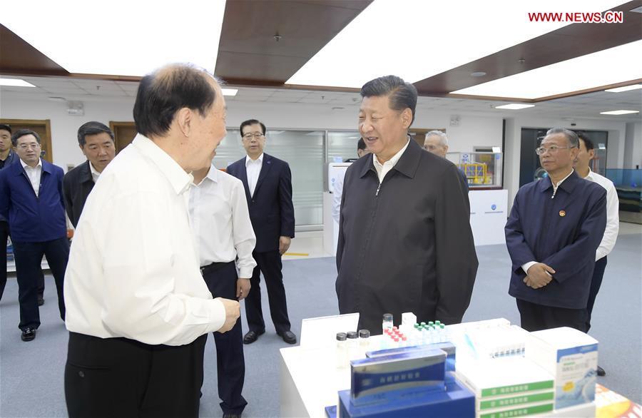 Chinese President Xi Jinping, also general secretary of the Communist Party of China Central Committee and chairman of the Central Military Commission, talks with academician of Chinese Academy of Engineering Guan Huashi at Pilot National Laboratory for Marine Science and Technology during an inspection tour in Qingdao, east China\'s Shandong Province, June 12, 2018. (Xinhua/Li Xueren)