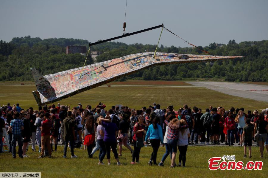 Photo taken on June 12, 2018 shows a massive paper airplane in Fitchburg, U.S. The 64-foot-long plane weighing in at over 1,500 pounds was put together by Project Soar at the Revolving Museum of Fitchburg. Creators of the paper airplane hope it will become a new Guinness World Record. (Photo/Agencies)