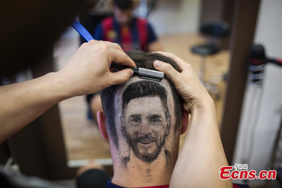 A fan of Lionel Messi shows his new haircut that features the face of the football star in Novi Sad, Serbia ahead of the World Cup. Barber Mario Hvala is famed for his salon in Novi Sad, where he shaves all manner of shapes and faces into customers\' hair. (Photo/Agencies)